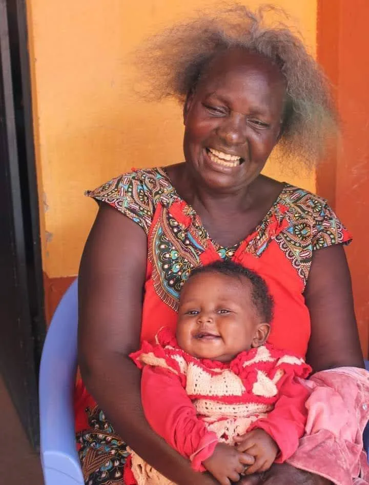 Pamela Adhiambo, founder of Hope for Children Kenya, holding one of the children